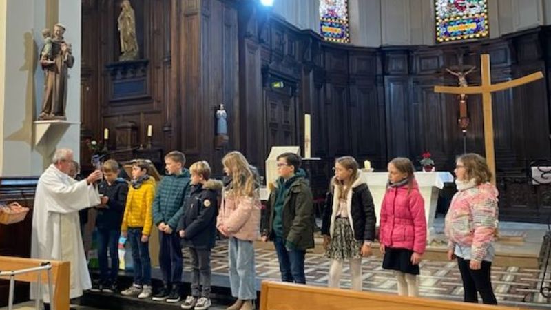 Les enfants dans le chœur recevant les évangiles